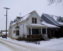 View of the Rehwinkel Parsonage looking toward the northwest corner of the house, with the west facade facing a laneway (January 2005); City of Edmonton, 2005