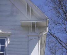 This photograph illustrates the large eave return, brackets and wide cornerboards, 2009; Town of St. Andrews