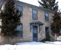 Featured is the symmetrical two-storey limestone facade.; Mary Tivy, 2008.
