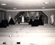 Sister of St. Joseph praying in the chapel, circa 1950s; City of Windsor, Planning Department