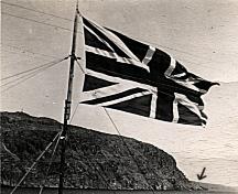View of the Old Lighthouse Site, indicated by an arrow in the background of the photo. The flag in the foreground is the John Guy Flag Site. Photo taken circa 1935.; Deborah O'Rielly/ HFNL 2008