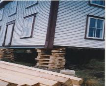 View of the underside of the moved dwelling showing the footing supports installed at the new location. Photo taken during restoration, about 2003.; HFNL 2009