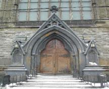 This photograph shows the elaborate Gothic entrance supported by small columns; City of Saint John