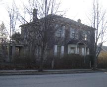 Of note is the hipped roof with two brick chimneys.; Emily Elliott, 2008.