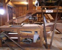 Interior view of the Esterhazy Flour Mill National Historic Site of Canada, showing the carter disc above and fanning mill below, 2007.; Agence Parcs Canada / Parks Canada Agency, A. Roos, 2007.