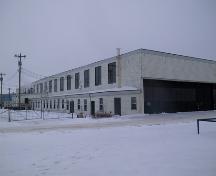 View of Hangar #14 looking toward the southwest corner showing the windows on the west facade and the large doors for movement of aircraft on the south facade (January 2005); City of Edmonton, 2005