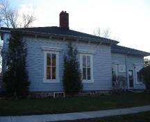 Of note are the roof brackets and frieze typical of the Greek Revival style.; Kayla Jonas, 2008.