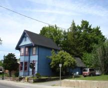 Side view showing original house behind front addition.; RHI 2006