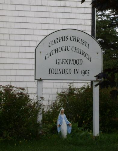 Showing sign and statue of Virgin Mary