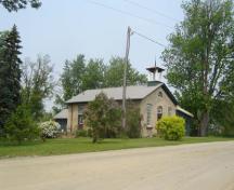 Of note are the wooden belfry and the gable roof.; Kayla Jonas, 2007.