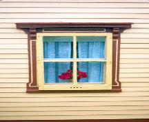 View of a window showing the carved and painted detail in the trim, the large rain cap and heavy brackets. Photo taken about 1995.; HFNL 2009