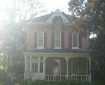 Of note is the open pediment with bullet window and bargeboard finial.; Martha Fallis, 2008.