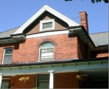 Featured is the second storey round-headed, double hung window and decorative gable.; City of Brantford, 2009.