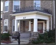 Featured is the elaborate veranda with low cut stone walls.; City of Brantford, 2003