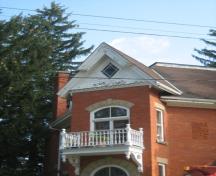 Of note is the gable with diamond shaped stained glass window.; Martha Fallis, 2008.