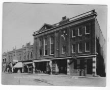Archival view showing the C.V.M. Café in its original streetscape context (to the left of large building in the foreground), Carberry, ca. 1900; Historic Resources Branch, Manitoba Culture, Heritage, Tourism and Sport, 2010