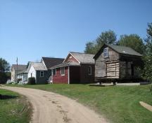 View of five buildings, with the Edwards log house in the foreground, 2009.; Ross Herrington, 2009.