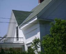 This photograph illustrates the large corner boards and eave returns at the side façade, 2009; Town of St. Andrews