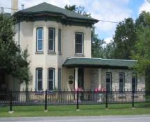 Of note is the two-storey bay window and hip roof with exaggerated eaves.; Sarah Middleton, 2008