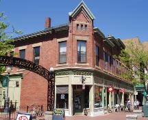 This 2004 photograph of the Victoria Block reveals the building's continuing viability as a retail and residential property.  Keating's Tobacco continues to occupy the prominent corner location.; Moncton Museum