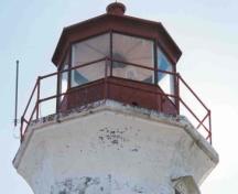 Detail view of the Lighthouse, showing the red lantern of standard depth, 2004.; Department of Transport / Ministère des Transports et Communications, 2004.
