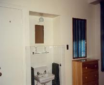 View of the Officer's Quarters, showing a typical room with a washbasin, 1995.; Department of National Defence / Ministère de la Défense nationale, 1995.