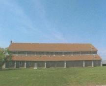 View of the exterior of the Recreational Hall, showing the regular pattern of fenestration, 2003.; Department of National Defence / Ministère de la Défense nationale, 2003.