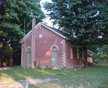 View of the exterior of Former Atha School House, showing the pattern of openings with two doors on the front façade (one for each gender), 2005.; Department of Public Works and Government Services / Ministère des Travaux publics et services gouvernementaux, Don Macdonald, 2005.