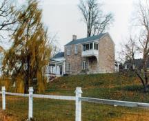 Rear view of the Superintendent's House, showing the small second-storey verandah protected by a pavilion roof, 1977.; Parks Canada Agency / Agence Parcs Canada, 1977.
