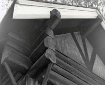 Detail view of the Gate Keeper's Residence, showing the walls of saddle-notched logs, 1984.; Parks Canada Agency / Agence Parcs Canada, S. Siepman, 1984.