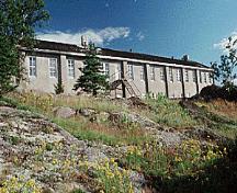 General view of Building 19, showing the regularly placed hung sash windows and doors, circa 2004.; Parks Canada Agency / Agence Parcs Canada, circa/vers 2004.