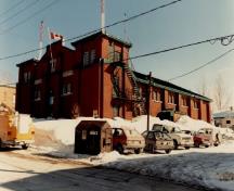 View of the Armoury, showing the red-brick load-bearing exterior walls, 1989.; Ministère de la Défense nationale / Department of National Defence, 1989.