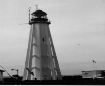 General View of the Light Tower, showing its tapered profile created by its flying buttresses and curving buttress attachments, 1980.; Canadian Coast Guardm, ca.1980. / Garde côtière canadienne, ca.1980.