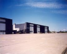 View of the Royal Canadian Air Force Hangar 8, showing the large open expanses of paved aprons and taxiways, 1998.; Department of National Defence / Ministère de la Défense nationale, 1998.