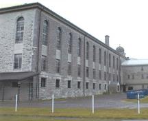 Corner view of the Administration and Main Cellblock Building, showing the main cell block section, 2000.; Bruce Macdonald, 2000.