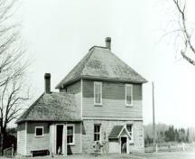 View of the rear façade of the Defensible Lockmaster's House, showing the exterior walls, the thick ground-floor walls constructed of limestone masonry, 1930.; Parks Canada Agency / Agence Parcs Canada, 1930.