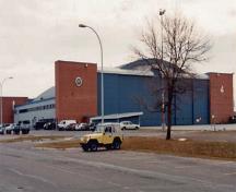 General view of Hangar 2 demonstrating the high, wide doorways that span its east and west elevations, the raised central sections for particularly high aircraft, and the brick pylons at each end, 2000.; Department of National Defence / Ministère de la Défense nationale, 2000.