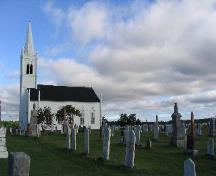 View of the St. Andrew's United Church Cemetery with the church in the backgound.; Village of Rexton