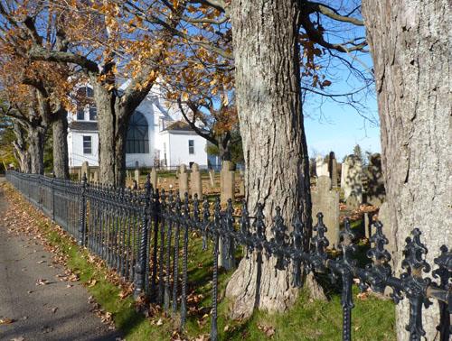 Along the western boundry of graveyard