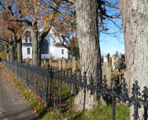 Wrought iron fence between the sidewalk and the Hillsborough Pioneer Cemetery.; Village of Hillsborough