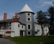 General view showing - its picturesque, eclectic design characteristics, including a variety of roof forms, differing front and rear facades, corner towers.; Parks Canada Agency / Agence Parcs Canada