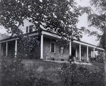 Historic photo of the portico along the front and both sides of building.; PANB P116-461