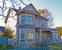 This image shows the southwest corner of the house. This home appears to be just a picket fence and rambling rose type of house. However it was home to one of the most properous businesses in the  village. ; Village of Hillsborough