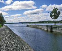 General view of Carillon Canal, showing the canal route leading to the present lock.; Parks Canada Agency / Agence Parcs Canada.