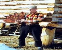 Knut Lang is carrying muskrat pelts.; Curtis Merrill/NWT Arcives/N-1992-192:0038