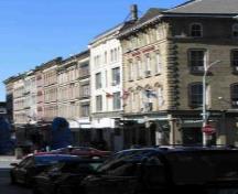 View of Granville Block, showing the similar four to five storey massings of the buildings with stone and brick façades, 2005.; Parks Canada Agency / Agence Parcs Canada, 2005.