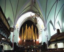 View of the interior of St. James United Church emphasizing the surviving original interior features at the north end of the sanctuary which typify Methodist churches of the period, including the communion rail, the pulpit platform, the pews for the choir; Parks Canada Agency / Agence Parcs Canada, D. Stiebeling
