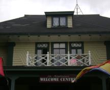 This photograph shows the balcony above the entrance, as well as the windows, the Corinthian capitals, modillions, and fancy shingling, 2007; Town of St. Andrews