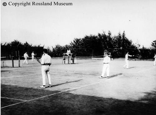 People playing tennis on courts, circa1910