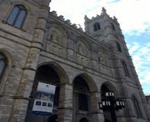 Corner view of the façade of the Notre-Dame Roman Catholic Church / Basilica; Parks Canada Agency | Agence Parcs Canada, S. Desjardins, 2016.